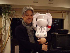 Sakamoto with a YMO doll (at his KAB office) | REALTOKYO